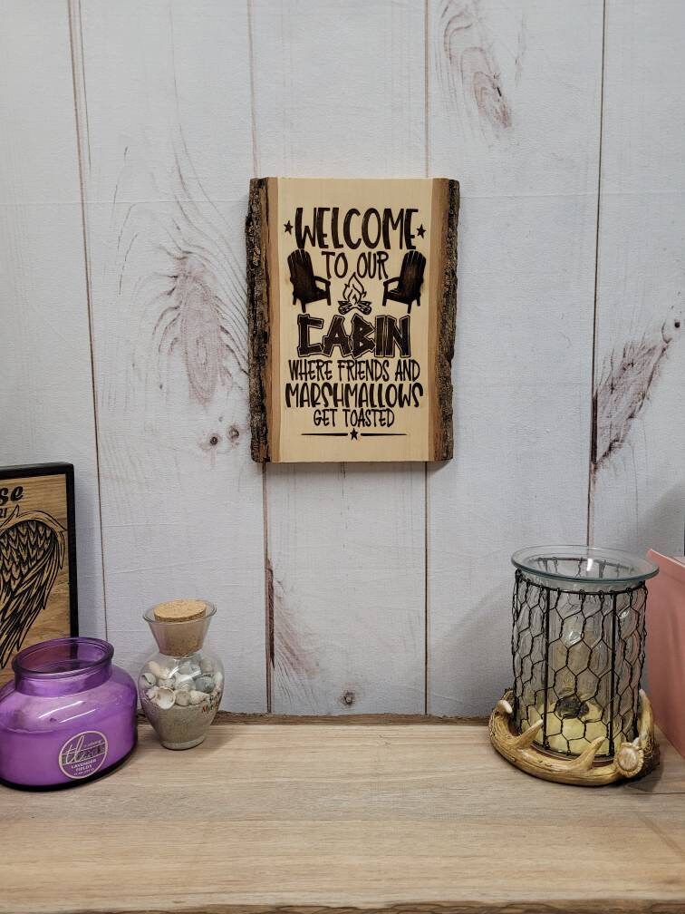 Live Edge Wood Cabin Sign Wood Sign — shown on a rustic wall