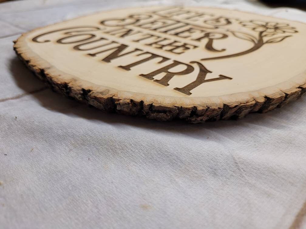 Country live edge wall hanging home decor lif Wood Sign — shown on a rustic wall