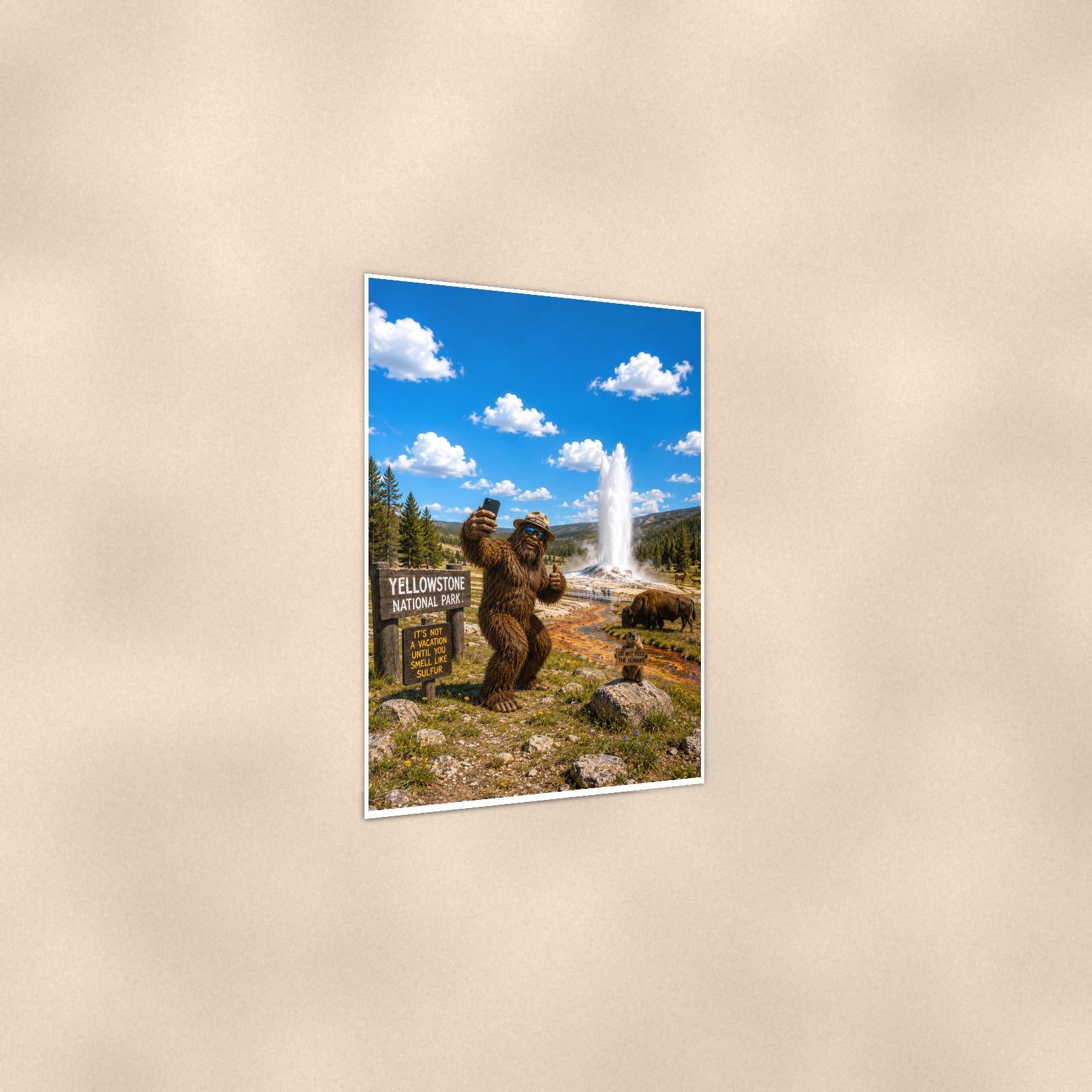 Yellowstone Bigfoot — 24x36 in art print poster, premium luster paper with a white border; gentle three-quarter angle on a warm wall, showing the flat paper edge.