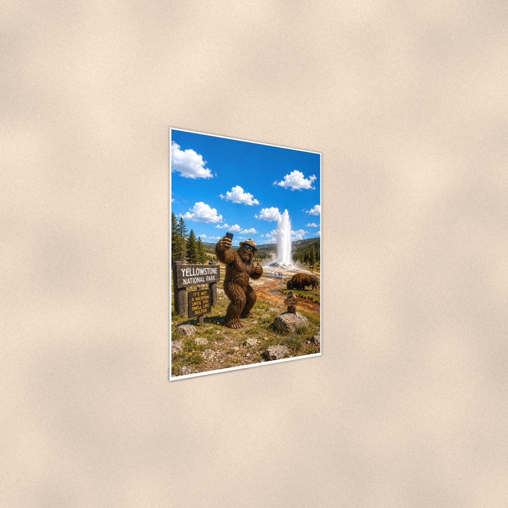 Yellowstone Bigfoot — 24x36 in art print poster, premium luster paper with a white border; steeper three-quarter angle on a warm wall, catching the luster sheen.