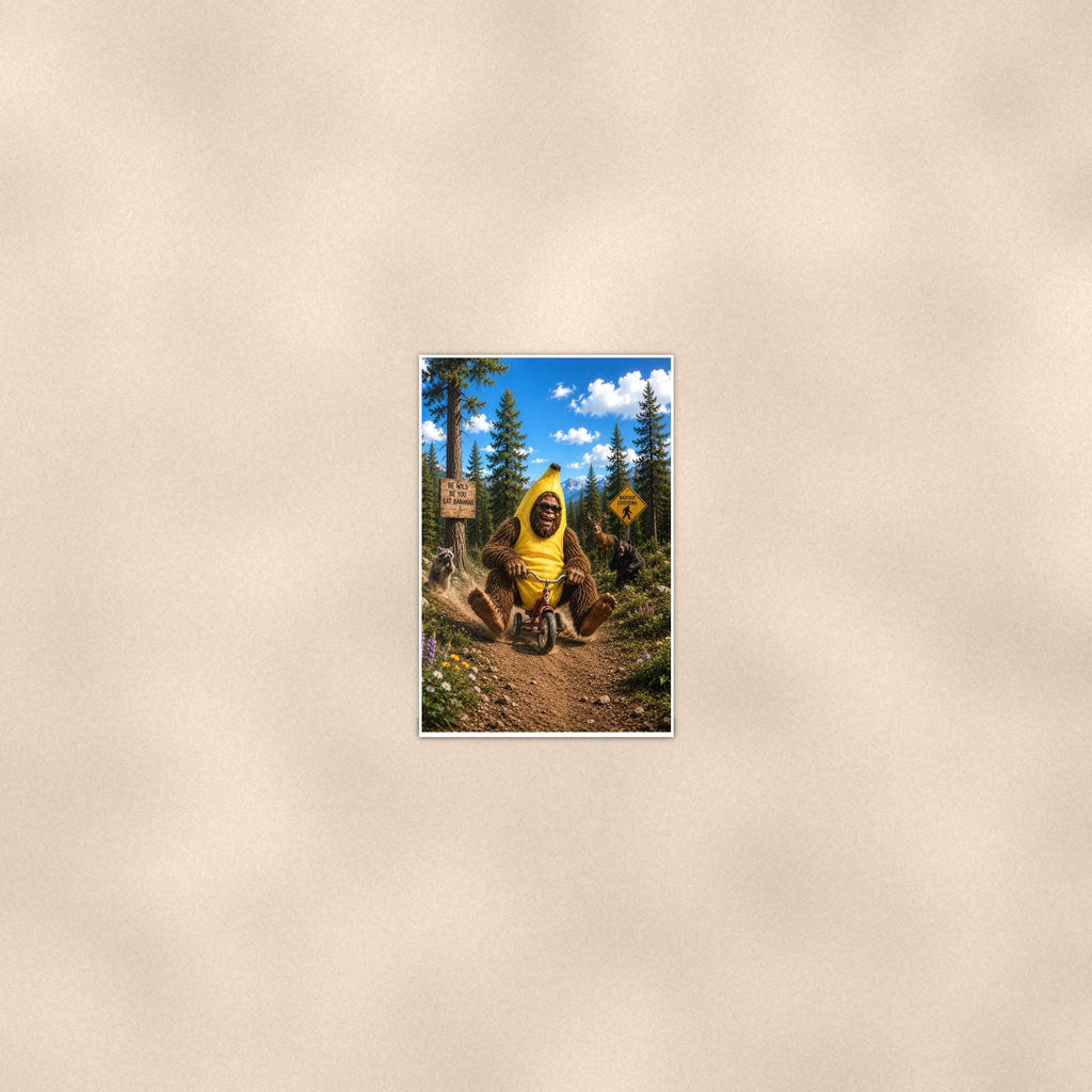 Banana Bike Bigfoot — 24x36 in art print poster, premium luster paper with a white border; poster seen from further back, at true 24x36 in scale on a warm wall.