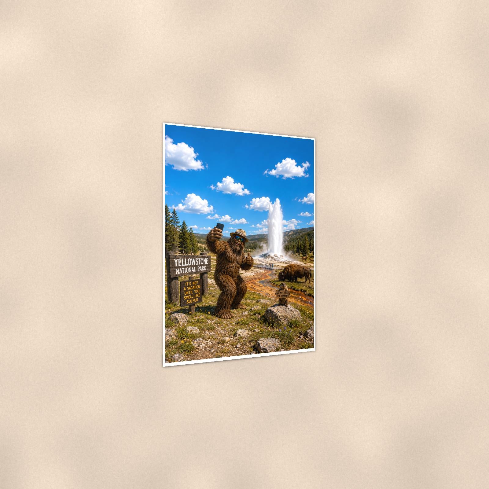 Yellowstone Bigfoot — 24x36 in art print poster, premium luster paper with a white border; gentle three-quarter angle on a warm wall, showing the flat paper edge.