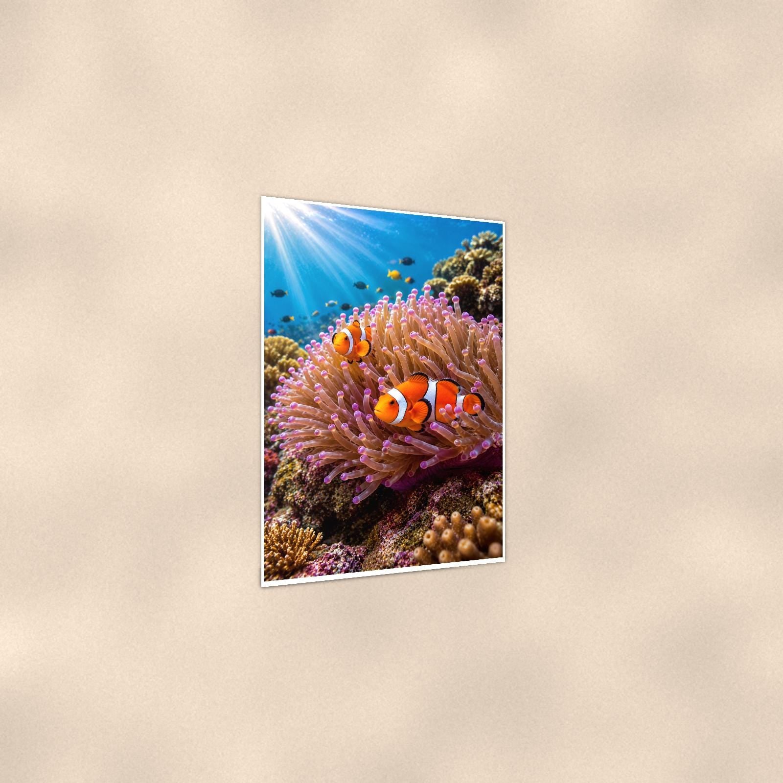 Clownfish and Anemone — 24x36 in art print poster, premium luster paper with a white border; gentle three-quarter angle on a warm wall, showing the flat paper edge.