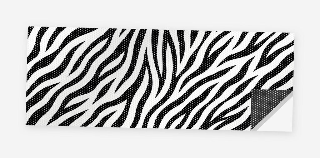 Zebra Print 68 x 18.5 inch perforated vinyl truck decal printed flat on white, corner folded up showing the perforation pattern and liner