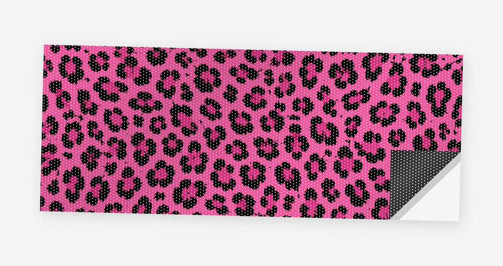 Pink Leopard Print 68 x 18.5 inch perforated vinyl truck decal printed flat on white, corner folded up showing the perforation pattern and liner