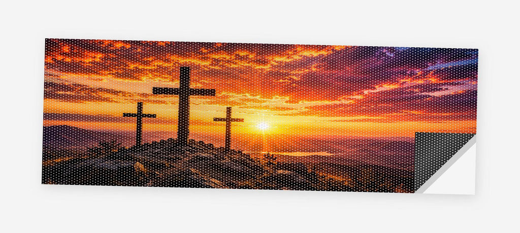 Three Crosses at Sunset 68 x 18.5 inch perforated vinyl truck decal printed flat on white, corner folded up showing the perforation pattern and liner