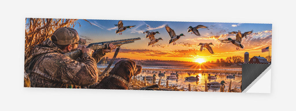 Duck Hunters at Dawn 68 x 18.5 inch perforated vinyl truck decal printed flat on white, corner folded up showing the perforation pattern and liner