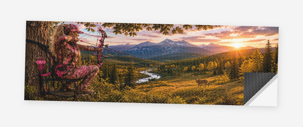 Country Girl Bowhunter 68 x 18.5 inch perforated vinyl truck decal printed flat on white, corner folded up showing the perforation pattern and liner