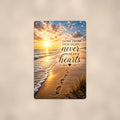 Footprints in the sand at sunset memorial art titled "Gone from our sight, never from our hearts" on a 8x12 inch sublimated aluminum sign with rounded corners and mounting holes, shown straight on against a warm neutral wall