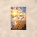 Footprints in the sand at sunset memorial art titled "Gone from our sight, never from our hearts" on a 24x36 inch luster poster print with a clean white border, shown straight on against a warm neutral wall