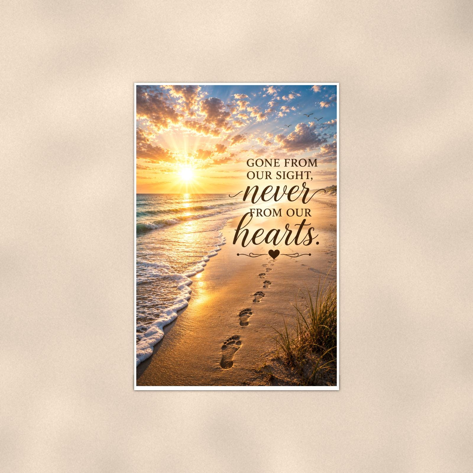 Footprints in the sand at sunset memorial art titled "Gone from our sight, never from our hearts" on a 24x36 inch luster poster print with a clean white border, shown straight on against a warm neutral wall