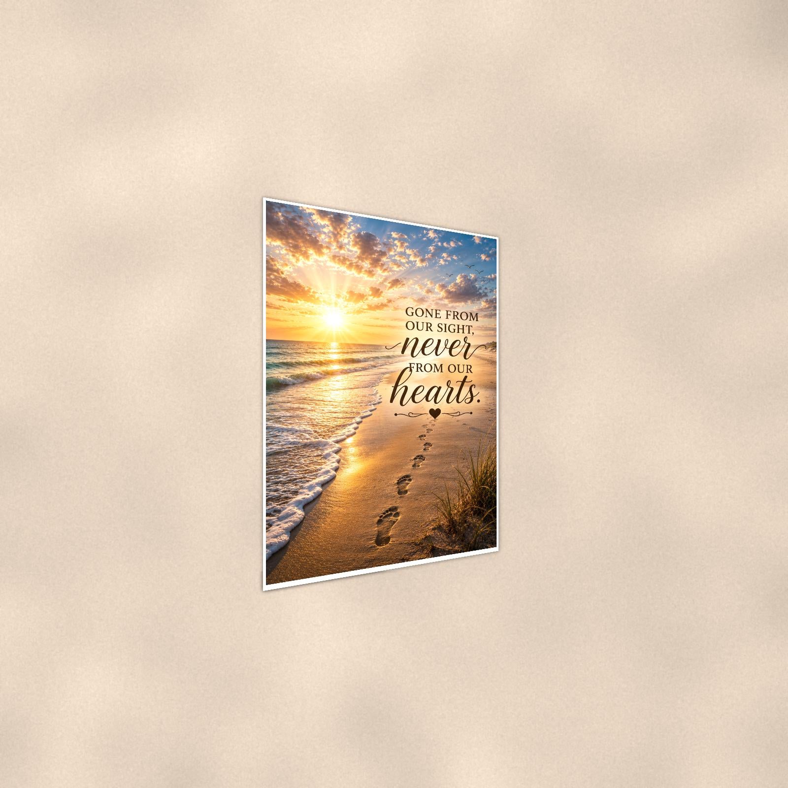 Footprints in the sand at sunset memorial art titled "Gone from our sight, never from our hearts" on a 24x36 inch luster poster print with a clean white border, shown at a gentle angle from the other side