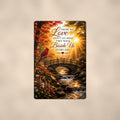 Cardinal over an autumn stream bridge memorial art titled "Those we Love don't go away, they walk Beside Us every day" on a 8x12 inch sublimated aluminum sign with rounded corners and mounting holes, shown straight on against a warm neutral wall
