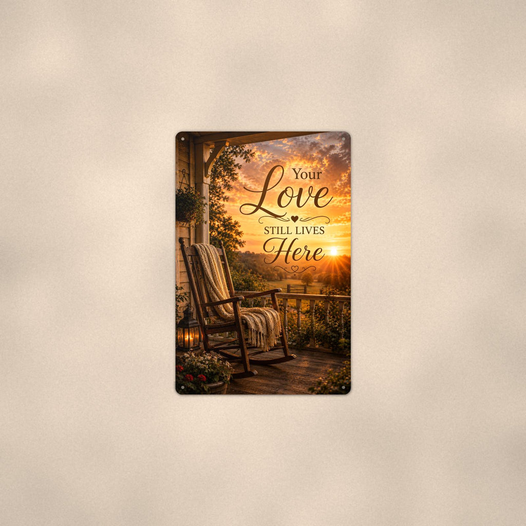 Rocking chair on the porch at sunset memorial art titled "Your Love Still Lives Here" on a 8x12 inch sublimated aluminum sign with rounded corners and mounting holes, shown at mid-distance centered on a warm wall