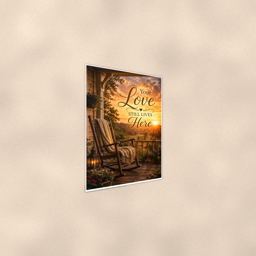 Rocking chair on the porch at sunset memorial art titled "Your Love Still Lives Here" on a 24x36 inch luster poster print with a clean white border, shown at a gentle angle from the other side