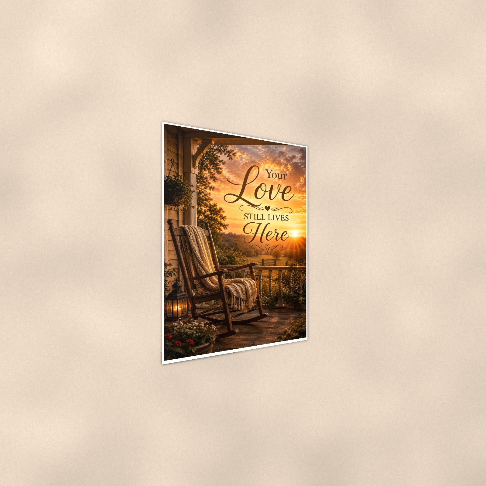 Rocking chair on the porch at sunset memorial art titled "Your Love Still Lives Here" on a 24x36 inch luster poster print with a clean white border, shown at a gentle angle from the other side