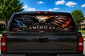 American Eagle Fire and Flag perforated rear-window decal installed on a pickup truck back glass, showing a screaming bald eagle with flag-feathered wings, lightning and crossed rifles