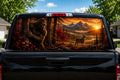 Bigfoot Tree Peeker Autumn perforated rear-window decal installed on a pickup truck back glass, showing a sasquatch peeking from behind a tree in a fall forest with a whitetail buck at sunset