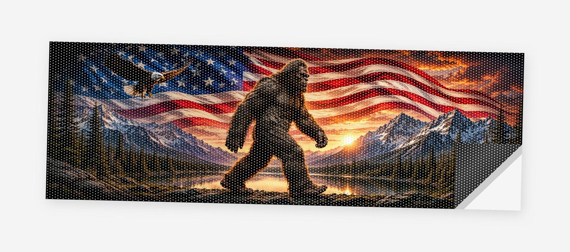Full flat view of the Bigfoot American Flag perforated truck window decal on a white background, one corner curled to show the black perf-vinyl backing and the micro-hole pattern