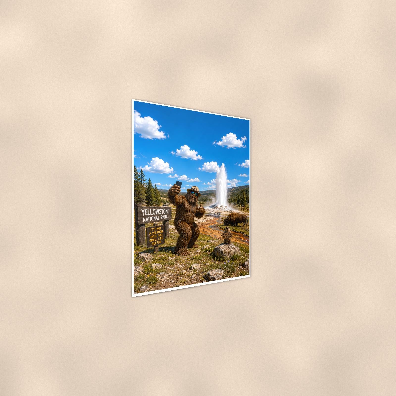 Yellowstone Bigfoot — 24x36 in art print poster, premium luster paper with a white border; steeper three-quarter angle on a warm wall, catching the luster sheen.