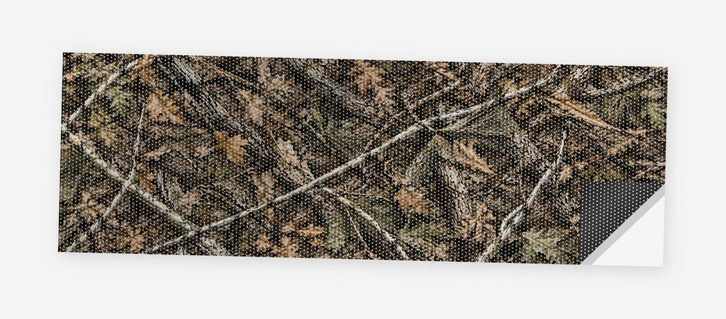 Woodland Camo 68 x 18.5 inch perforated vinyl truck decal printed flat on white, corner folded up showing the perforation pattern and liner