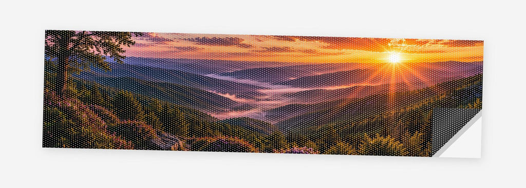 Blue Ridge Sunset 68 x 18.5 inch perforated vinyl truck decal printed flat on white, corner folded up showing the perforation pattern and liner