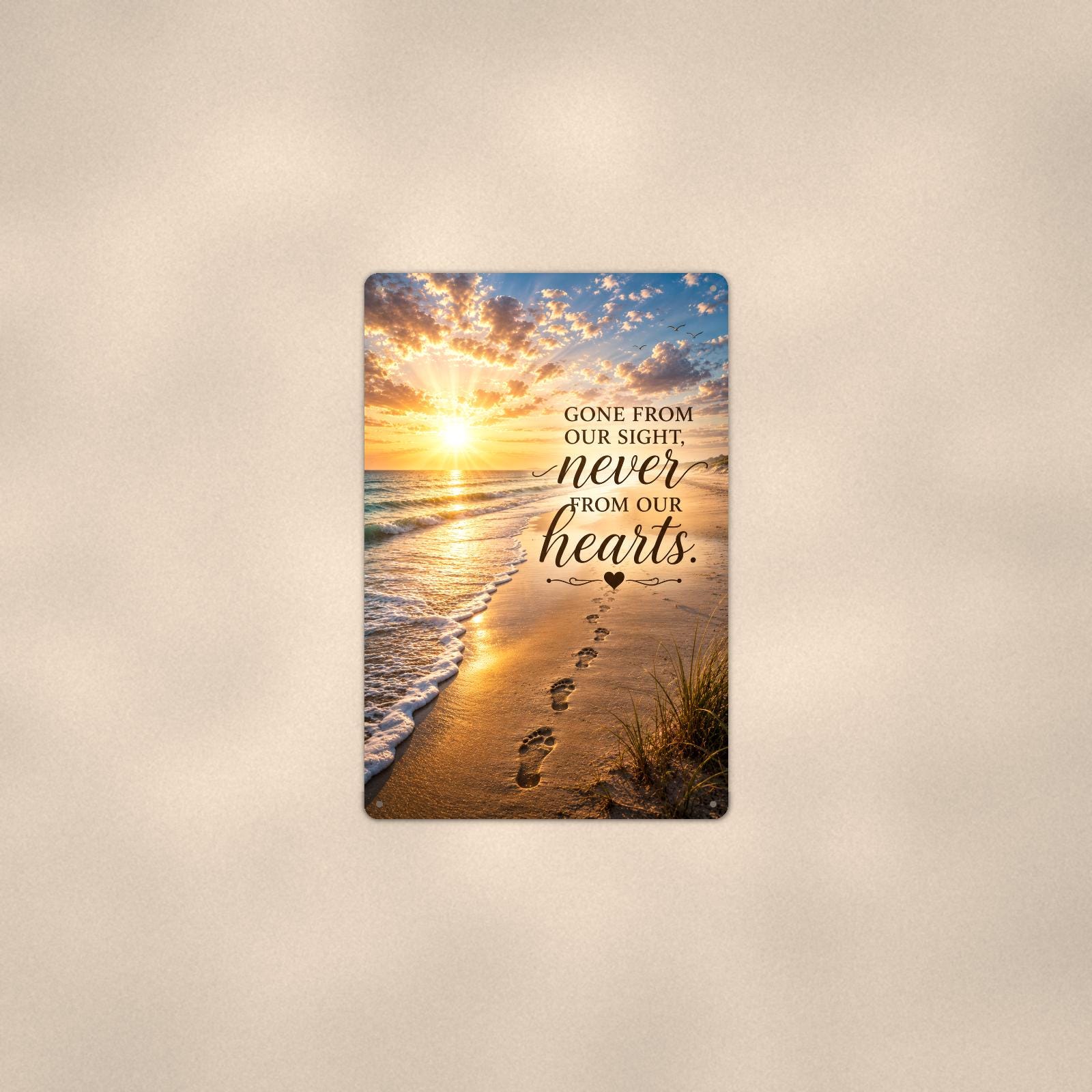 Footprints in the sand at sunset memorial art titled "Gone from our sight, never from our hearts" on a 8x12 inch sublimated aluminum sign with rounded corners and mounting holes, shown at mid-distance centered on a warm wall