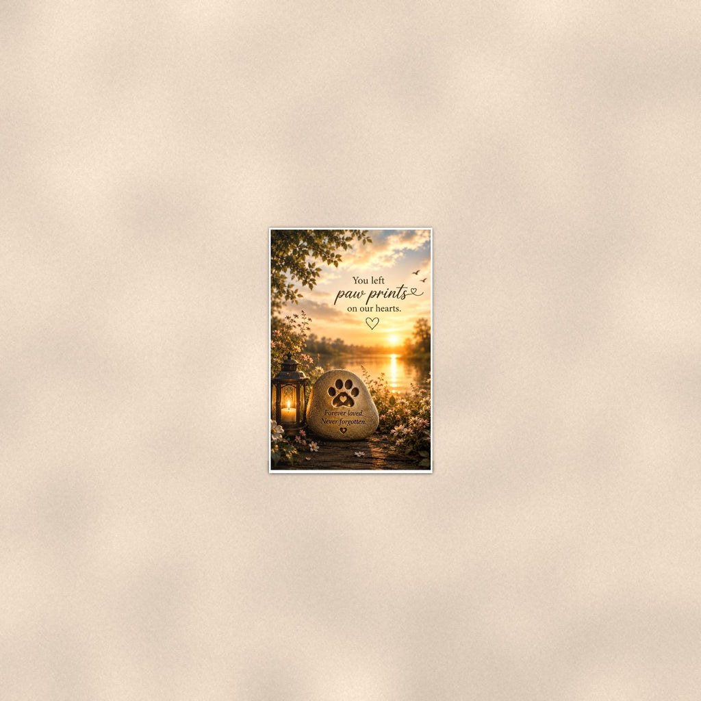 Paw print memorial stone by the lake memorial art titled "You left paw prints on our hearts" on a 24x36 inch luster poster print with a clean white border, seen from farther back, small on a softly lit wall