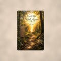 Sunlit forest path with a rustic memory sign memorial art titled "Until We Meet Again - In Our Hearts Forever" on a 8x12 inch sublimated aluminum sign with rounded corners and mounting holes, shown straight on against a warm neutral wall