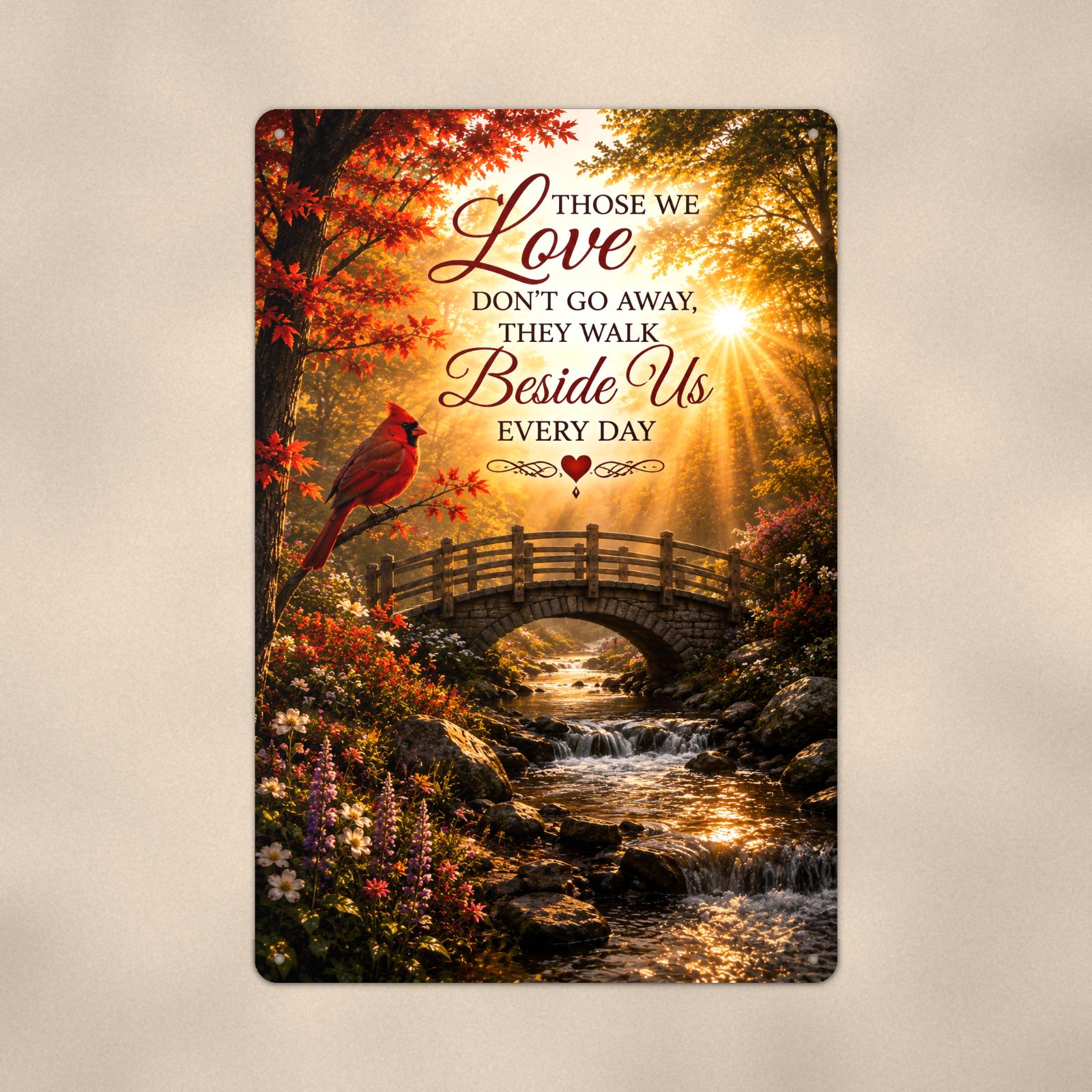 Cardinal over an autumn stream bridge memorial art titled "Those we Love don't go away, they walk Beside Us every day" on a 8x12 inch sublimated aluminum sign with rounded corners and mounting holes, close-up view filling the frame, showing the smoot