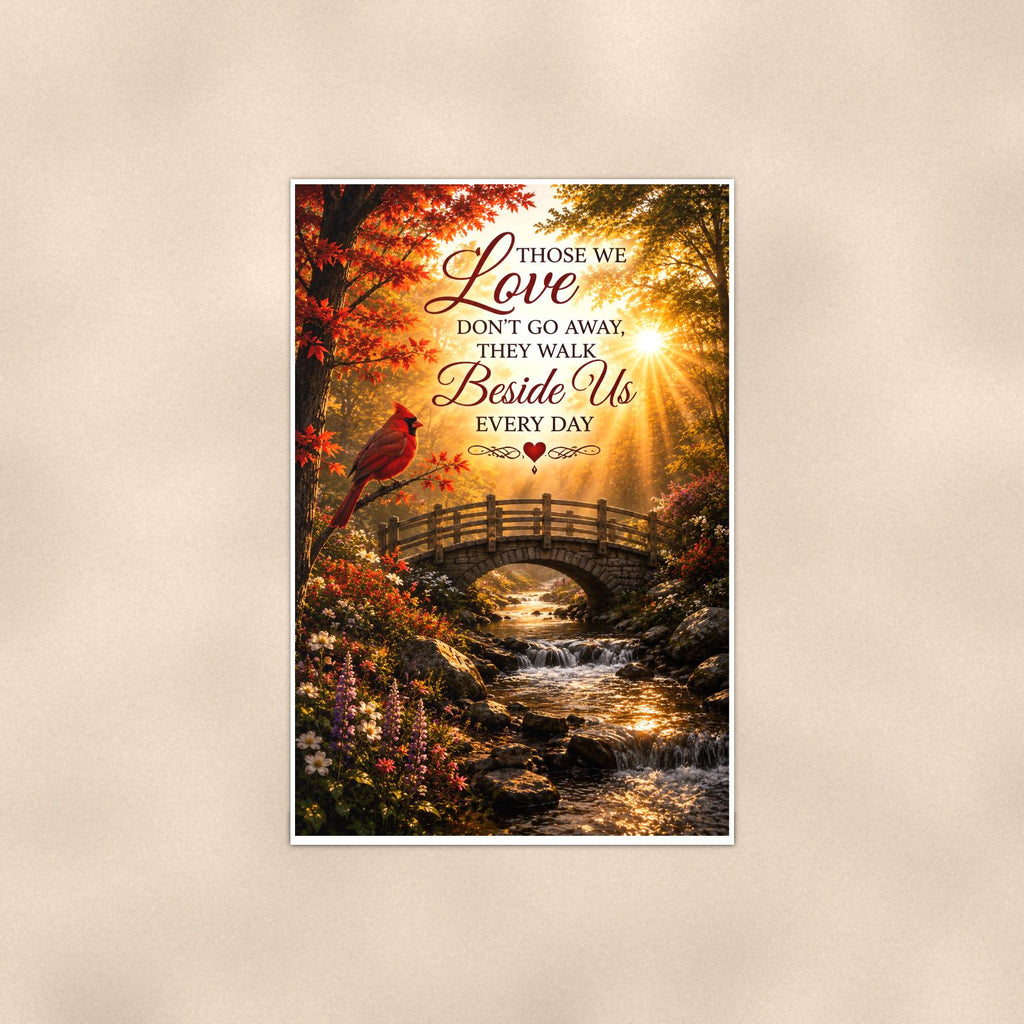 Cardinal over an autumn stream bridge memorial art titled "Those we Love don't go away, they walk Beside Us every day" on a 24x36 inch luster poster print with a clean white border, shown straight on against a warm neutral wall