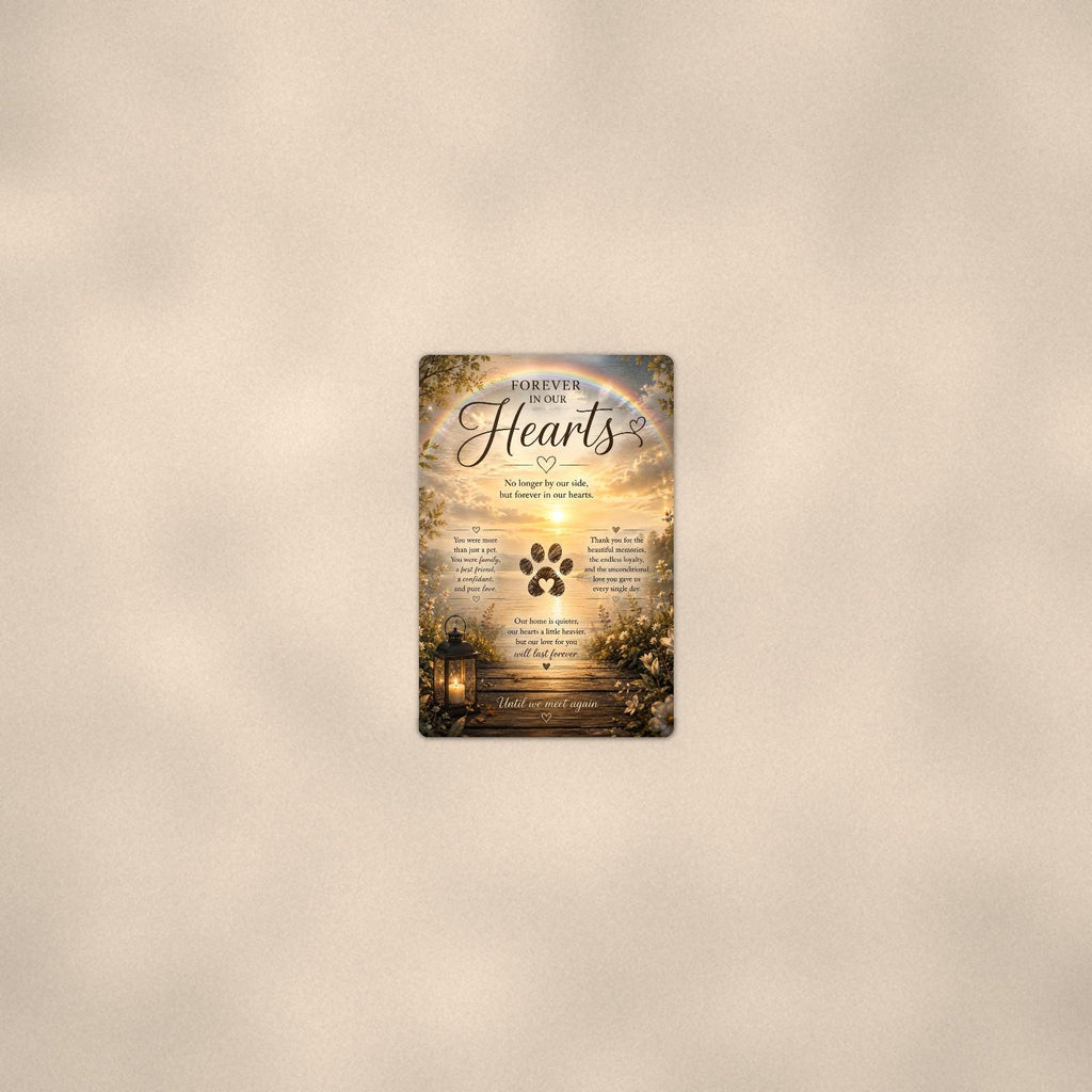 Rainbow over a sunset lake with a paw print memorial art titled "Forever In Our Hearts" on a 8x12 inch sublimated aluminum sign with rounded corners and mounting holes, seen from farther back, small on a softly lit wall