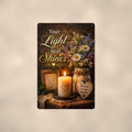 Candlelight remembrance still life memorial art titled "Your Light Still Shines" on a 8x12 inch sublimated aluminum sign with rounded corners and mounting holes, shown straight on against a warm neutral wall