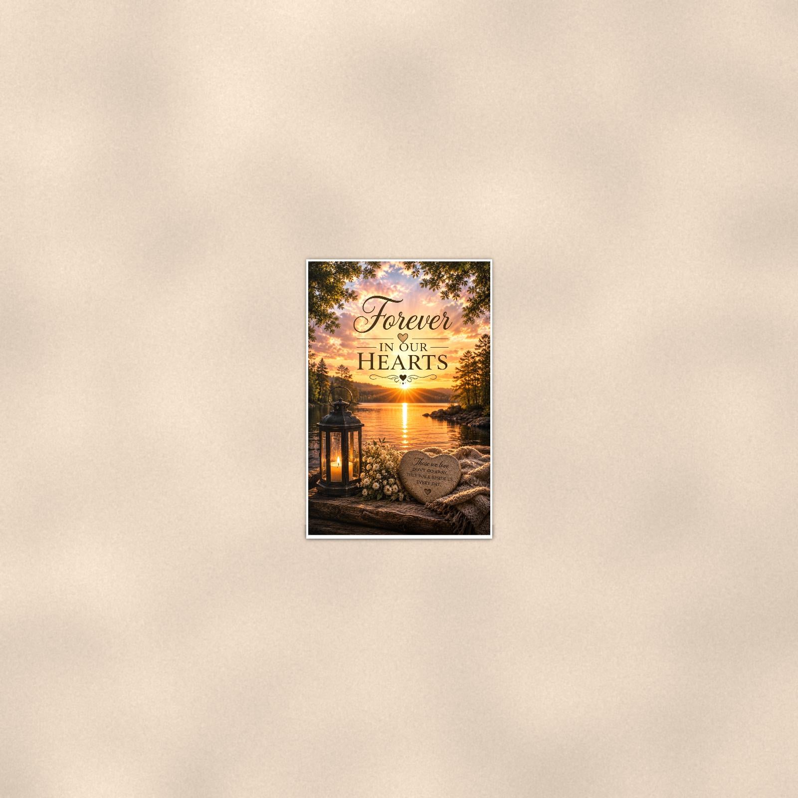 Lakeside lantern and heart stone memorial art titled "Forever In Our Hearts" on a 24x36 inch luster poster print with a clean white border, seen from farther back, small on a softly lit wall