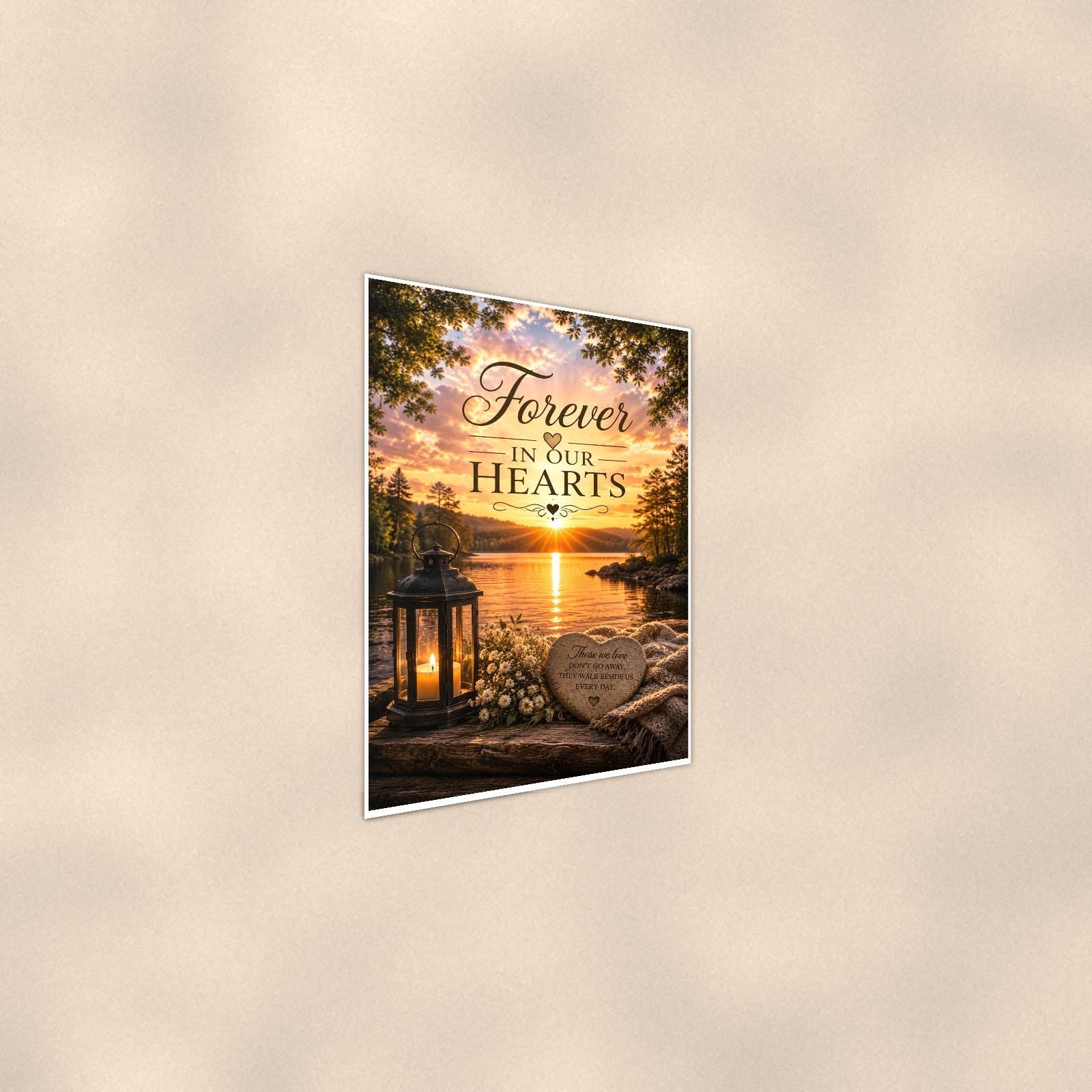 Lakeside lantern and heart stone memorial art titled "Forever In Our Hearts" on a 24x36 inch luster poster print with a clean white border, shown at a gentle angle from the other side