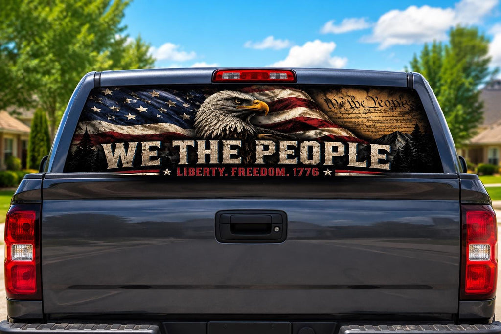 We The People perforated rear-window decal installed on a pickup truck back glass, showing a bald eagle, waving American flag and the Constitution parchment