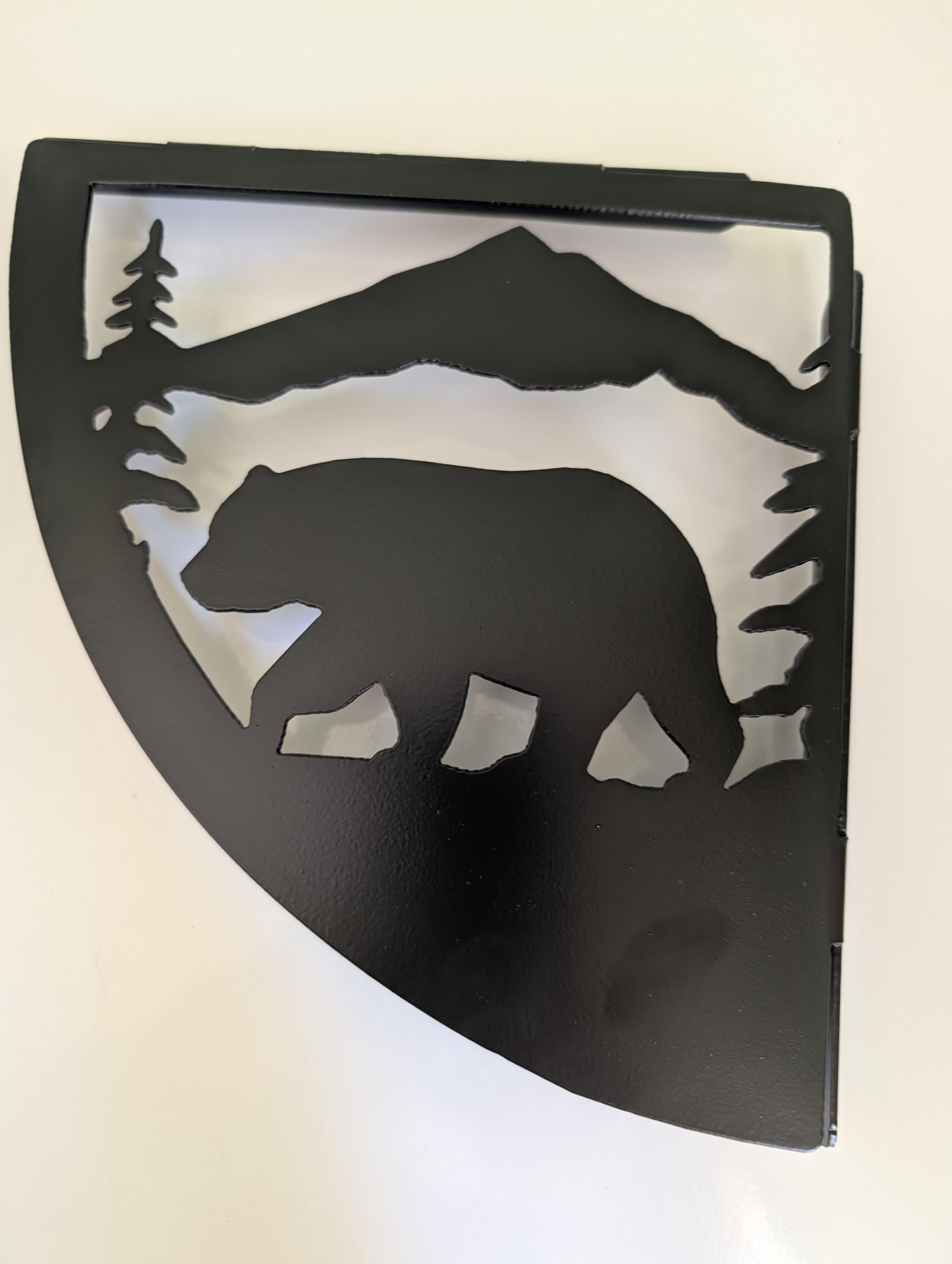 Close-up of the mountain bear shelf bracket showing the plasma cut bear walking under a mountain ridge with pine trees