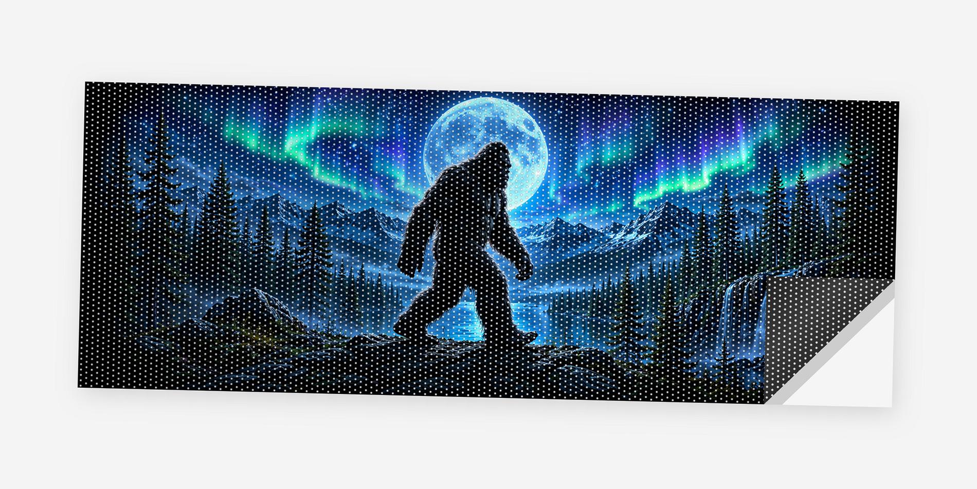 Full flat view of the Bigfoot Northern Lights perforated truck window decal on a white background, one corner curled to show the black perf-vinyl backing and the micro-hole pattern