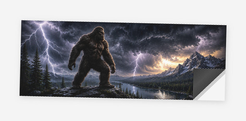 Full flat view of the Bigfoot Storm Walker perforated truck window decal on a white background, one corner curled to show the black perf-vinyl backing and the micro-hole pattern