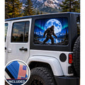 Jeep Wrangler 4-door rear quarter window with a perforated decal of Bigfoot walking beside a mountain lake under a full moon and green and purple northern lights, applied to the outside of the glass. An INCLUDED badge in the corner shows the felt squeegee and 2 American flag decals that come with every set.
