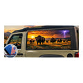 Jeep Wrangler 2-door rear side window with a perforated decal of a bison herd grazing on the prairie at sunset, a lightning storm with purple clouds rolling in on the right side of the scene, applied to the outside of the glass. An INCLUDED badge in the corner shows the felt squeegee and 2 American flag decals that come with every set.