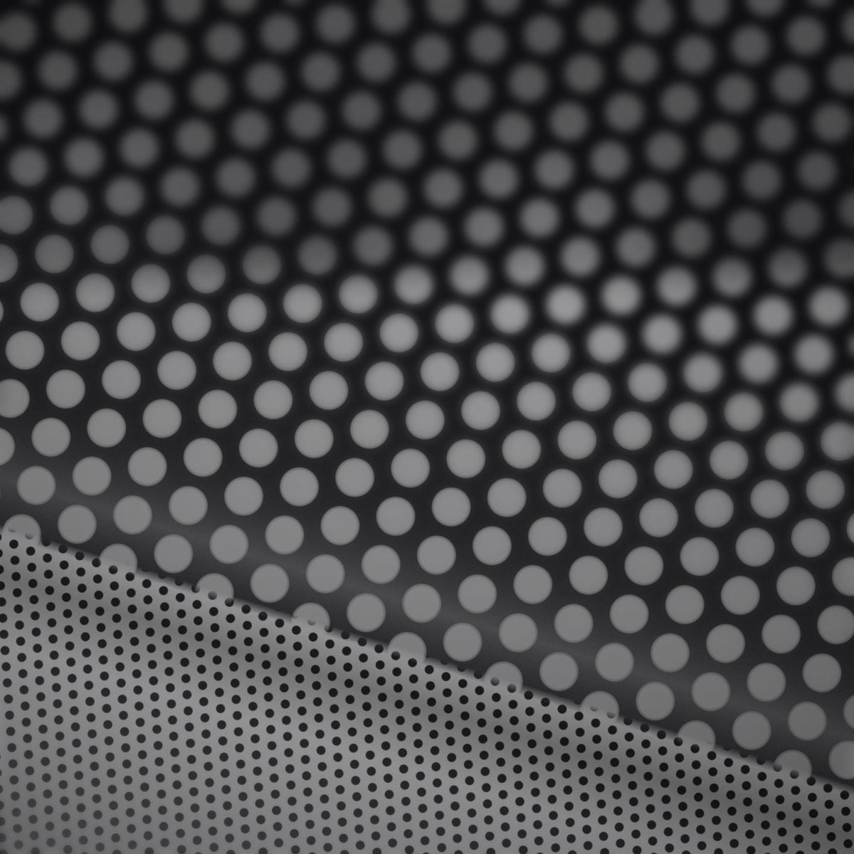 Extreme macro close-up of the perforated vinyl surface showing the printed face and the micro-perforation holes that create the one-way see-through effect.