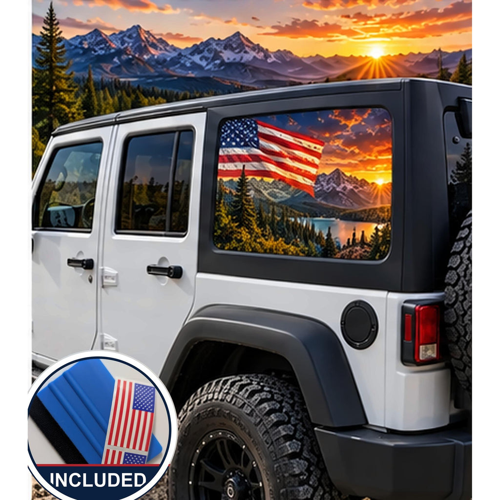 Jeep Wrangler 4-door rear quarter window with a perforated decal of a waving American flag over snow-capped mountains and a small pond at a fiery orange sunset, applied to the outside of the glass. An INCLUDED badge in the corner shows the felt squeegee and 2 American flag decals that come with every set.